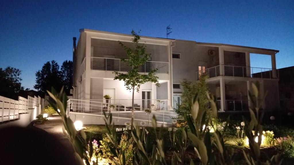 a large white house with lights in front of it at L'ulivo D'oro in Laterza