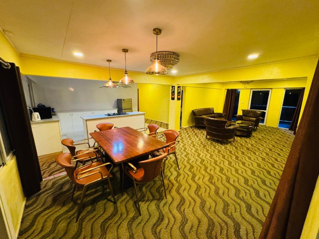 a dining room with a table and chairs at A1 Apartments in Suva