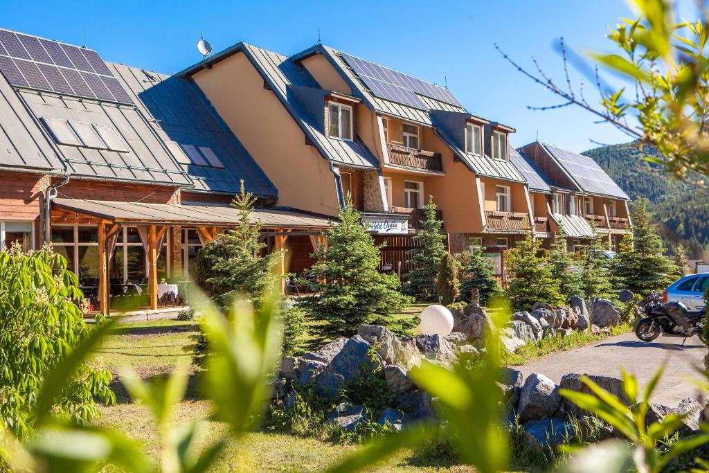 a row of houses with solar panels on their roofs at Hotel Osrblie in Osrblie