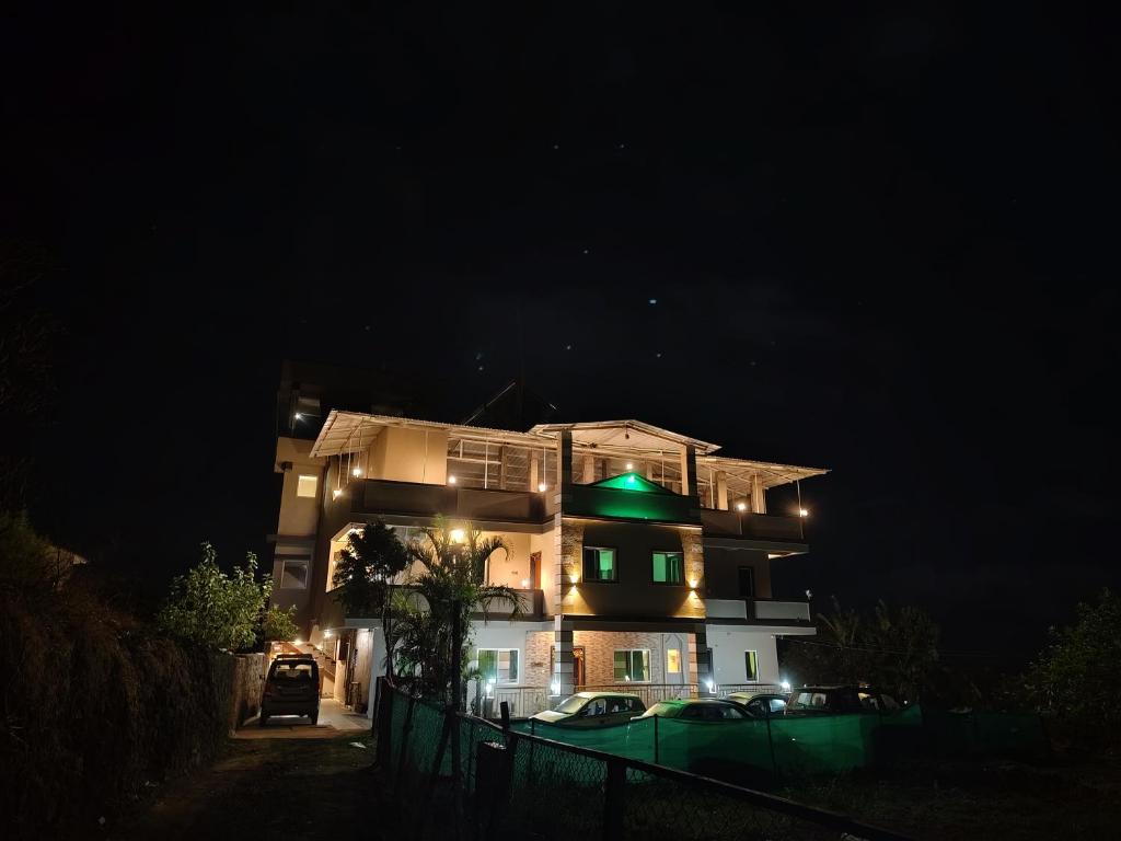 a building with a green light on it at night at Hotel Green lotus villa mahabaleshwar in Mahabaleshwar