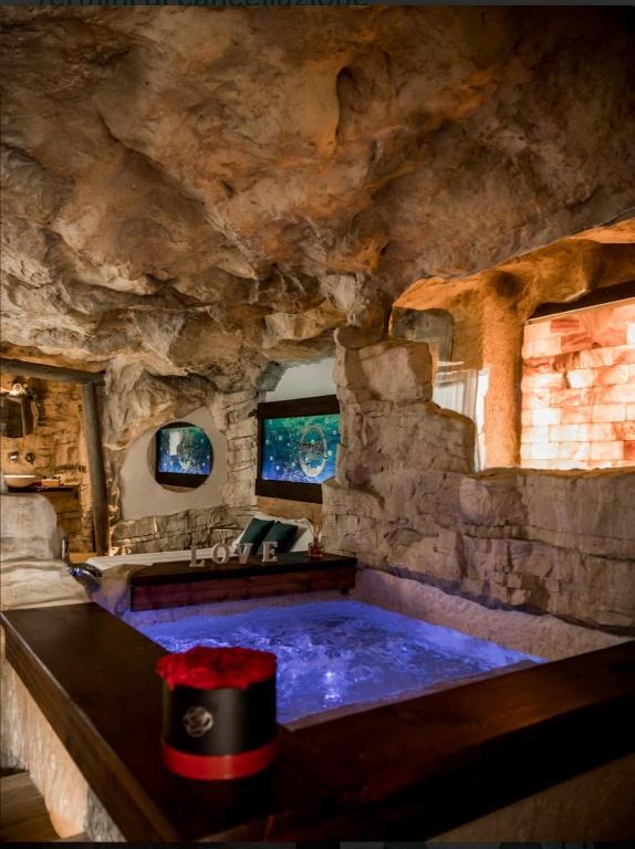 a room with a large tub in a stone cave at EmmejSuite in Pozzuoli
