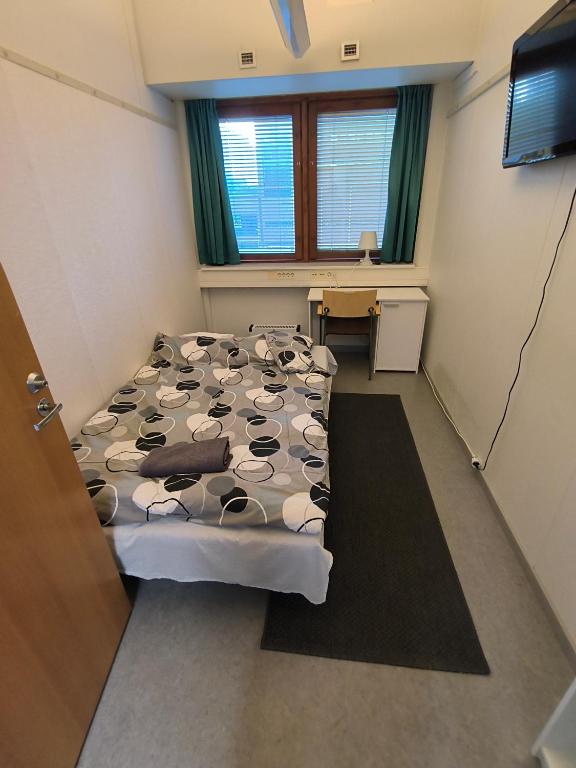 a hospital room with a bed and a desk at Office House Tripla in Helsinki