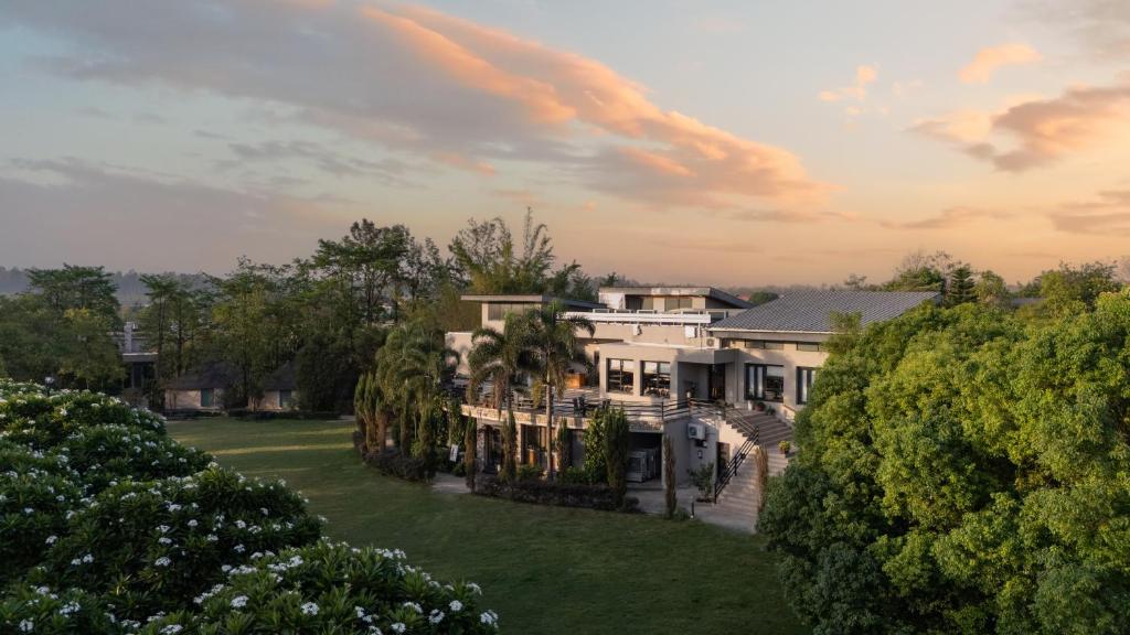 an aerial view of a large house with trees at The Golden Tusk By Ivory Destinations in Rāmnagar