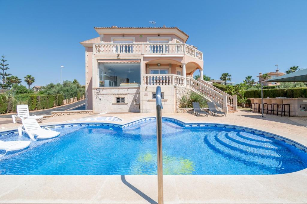 a villa with a swimming pool and a house at Can Martinez in Llucmajor