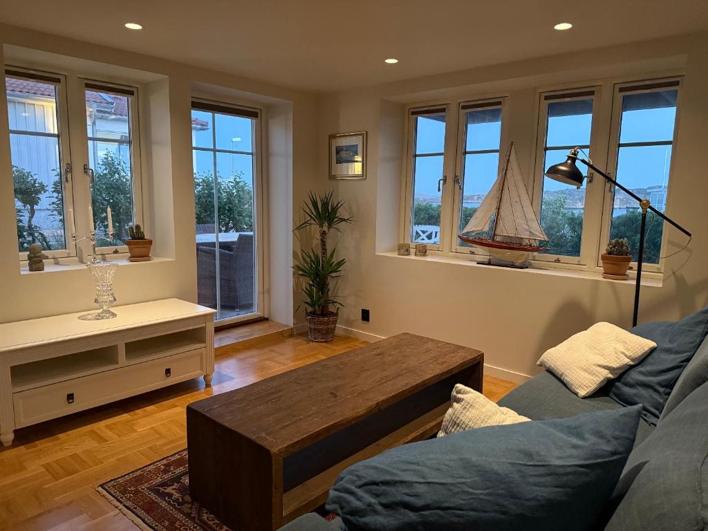 a living room with a couch and a coffee table at Fisketången Seaside Stay in Kungshamn
