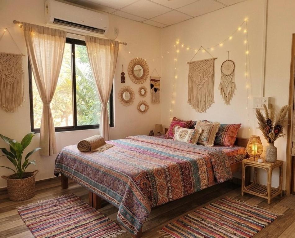 a bedroom with a bed and lights on the wall at The Nivasa Project in Agonda