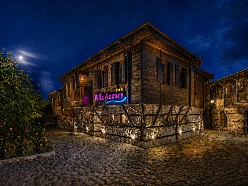 a building with a sign on the side of it at night at Effect Boutique Villa Azzura - Adults Only SELF CHECK-IN in Nesebar