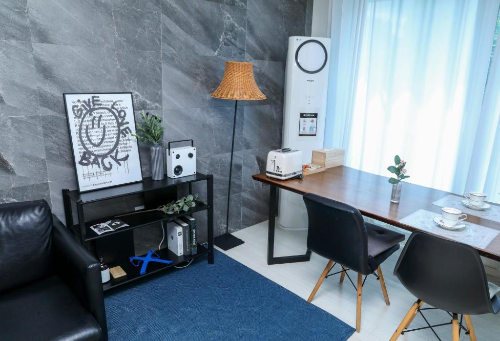 a room with a table and chairs and a lamp at Fresh Stay in Seoul