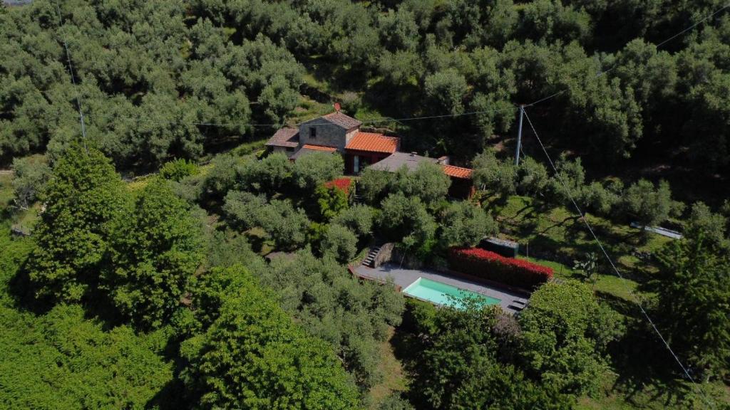 an aerial view of a house in the middle of a forest at Tuscan house, exclusive pool, private garden in Bagni di Lucca