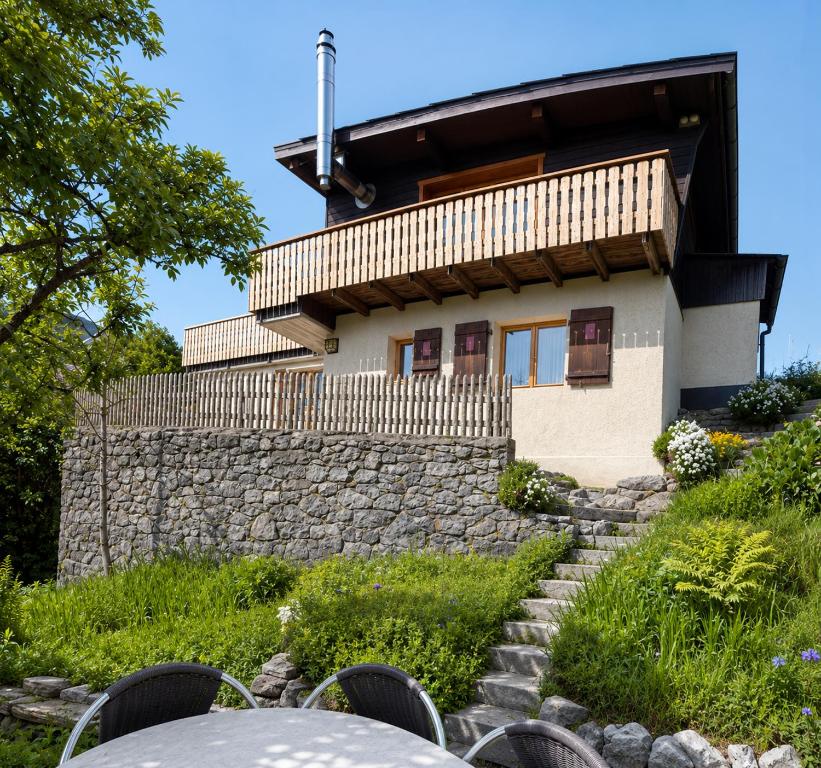 a house on top of a stone wall at Chalet Montana mit Bergblick in Brunig