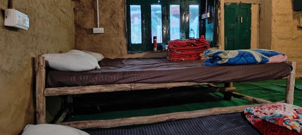 a bedroom with two bunk beds in a room at Heritage hut in Vashisht