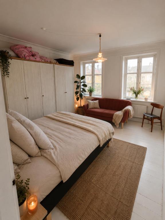 a bedroom with a large bed and a living room at Kysthus Villa Nexø in Neksø