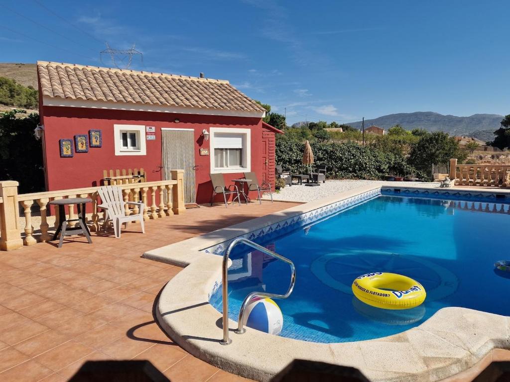 a house with a swimming pool in front of a house at Casita Casa la Rambla in La Romana