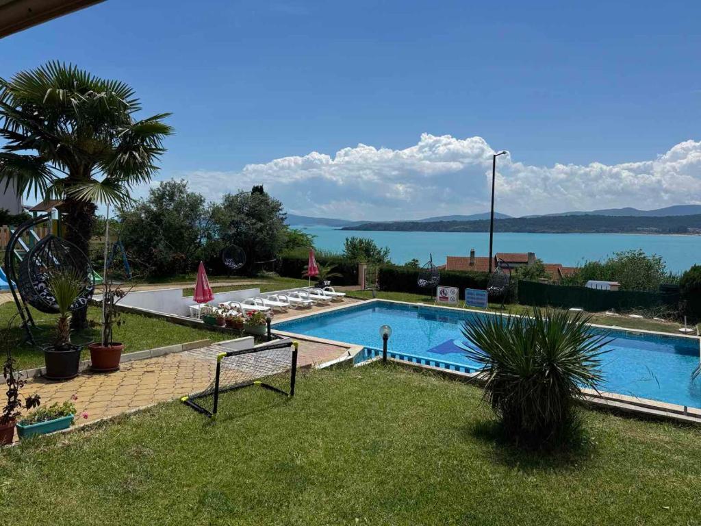 a swimming pool with a view of the water at Safo Apartments and Rooms in Sozopol