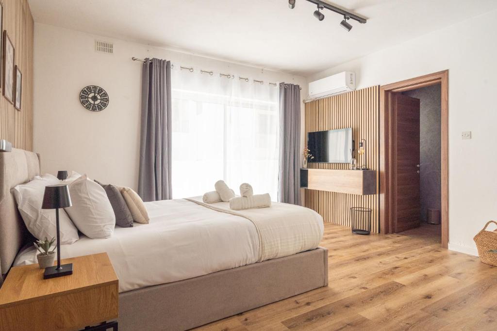 a bedroom with a large bed and a large window at Slimiza in Sliema