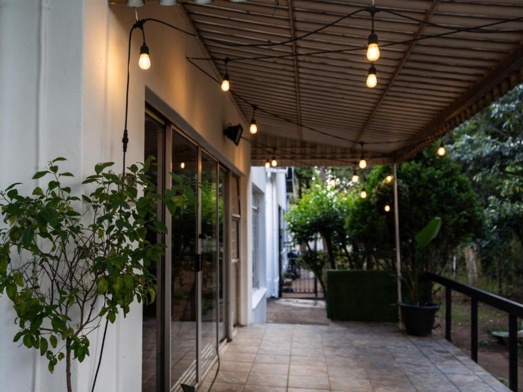 a patio with awning and lights on a building at Leaf & Lark in Bloemfontein