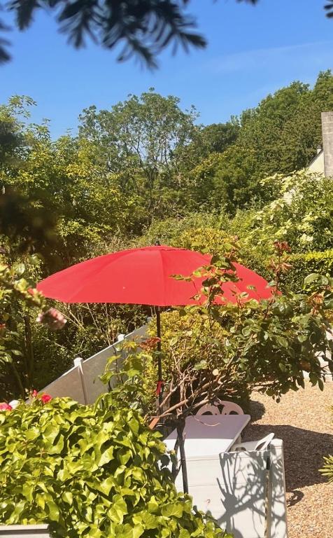 a red umbrella sitting on top of a table at Appartement causy in Gonfreville-lʼOrcher