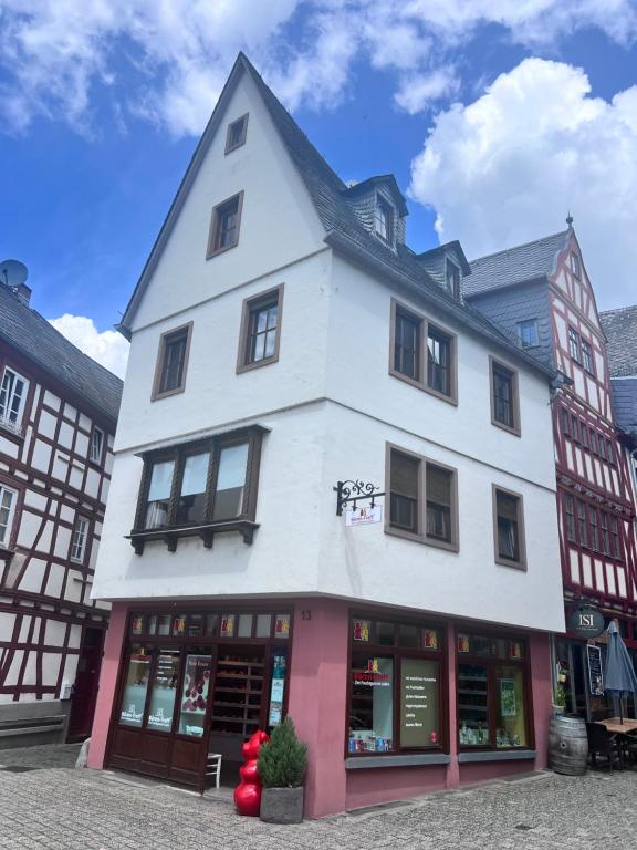 a large white building with windows on a street at Modernes Altstadtappartment Suite Plötze 13 Limburg in Limburg an der Lahn
