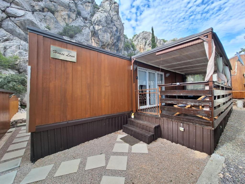 a building with a mountain in the background at Spacious Mobile Home "House Lena" for 7 in Eurocamp Rača - Sea View & Private terrace in Sveti Juraj