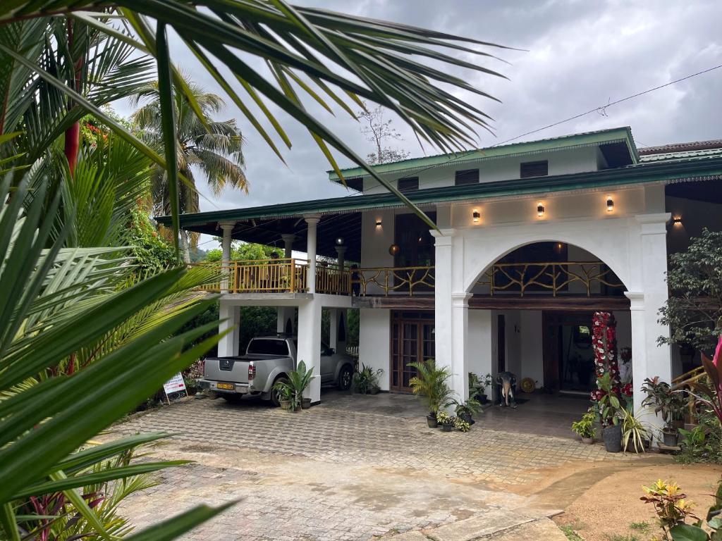 a house with a truck parked in front of it at Benvilla Kandy in Kandy