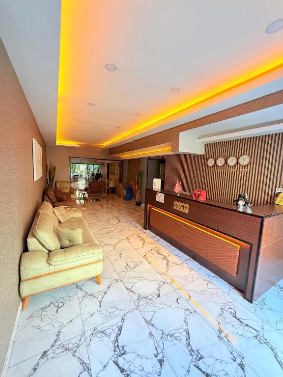 a living room with a couch and a table at Side Ertaş Otel in Side