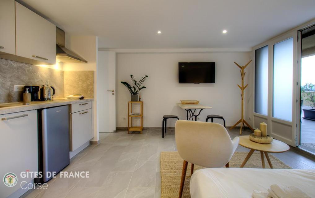 a kitchen and living room with a couch and a table at Casa s - lilina in Tralonca