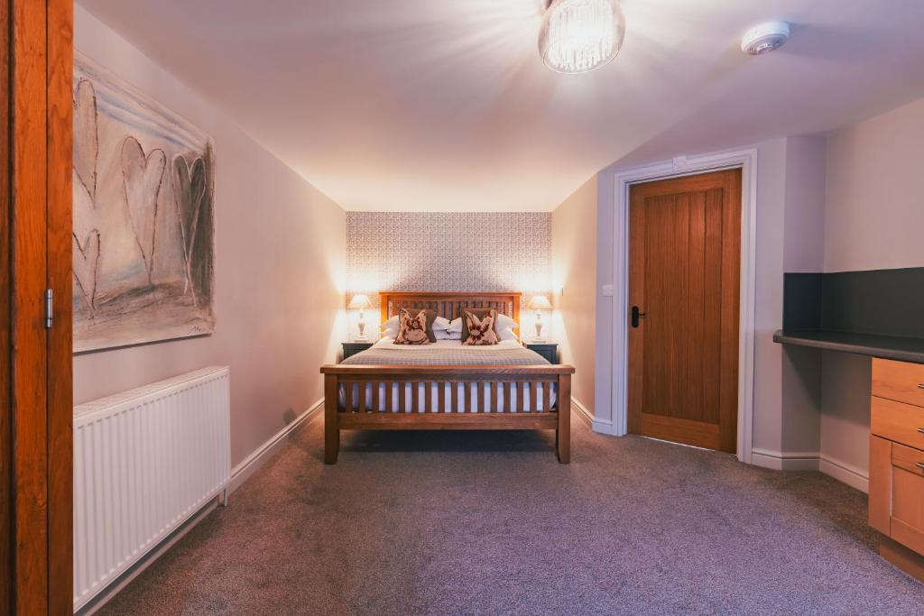a bedroom with a bed and a television in it at Home Farm & Lodge in Bawtry