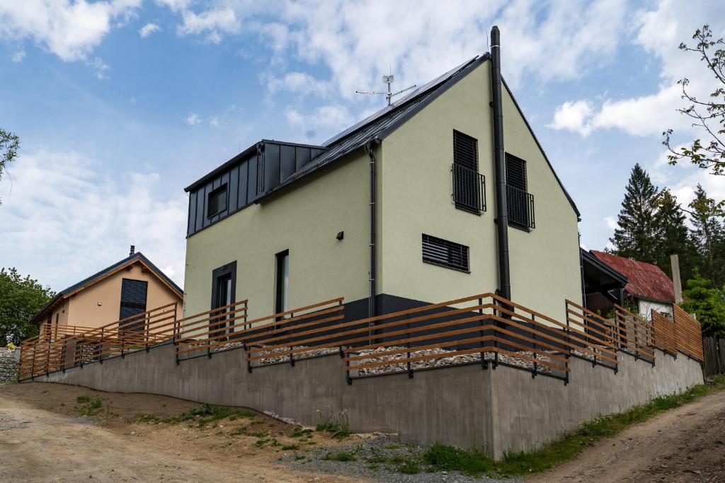 a large white building with a black roof at Chata Vali in Loučovice