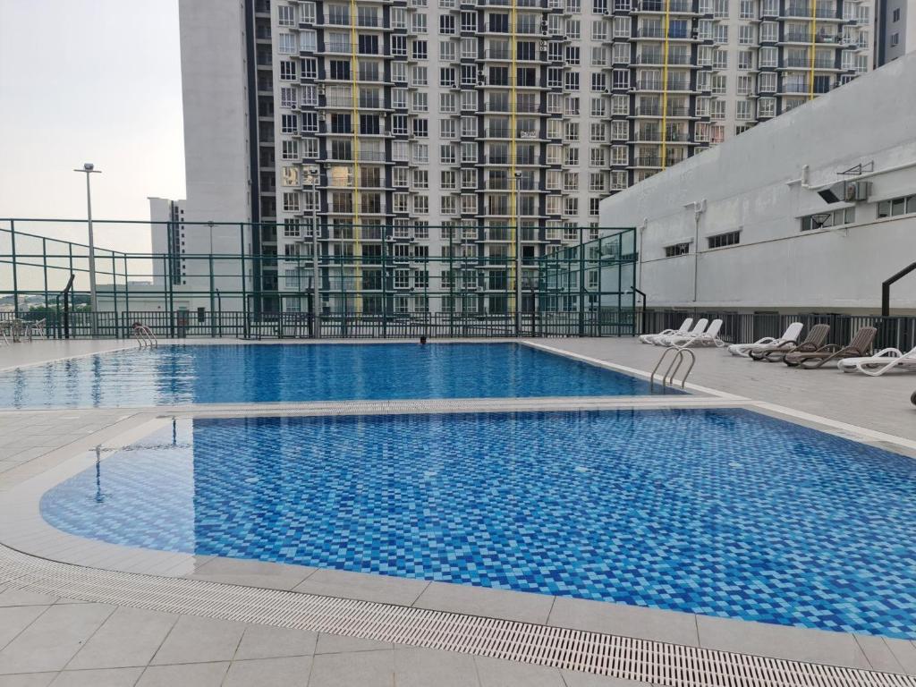 a large swimming pool on top of a building at Aariz Homestay in Malacca