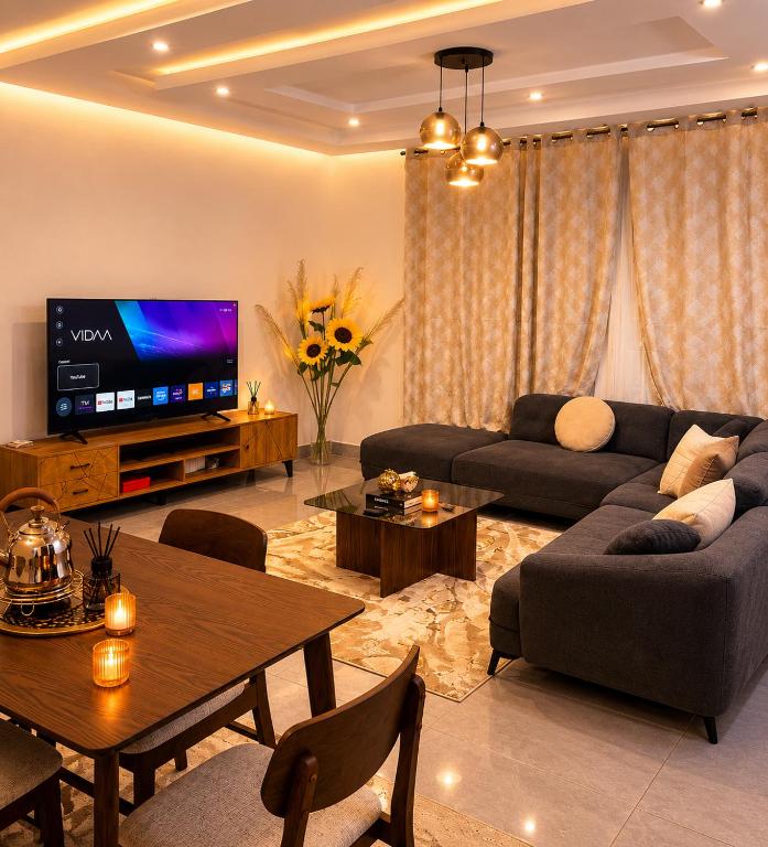 a living room with a couch and a tv at Djess in Abidjan