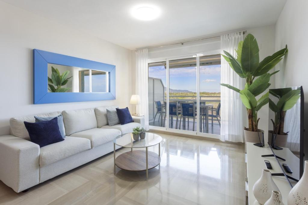 a living room with a white couch and a table at AG Aiguablava Vista Mar in Playa de Gandia