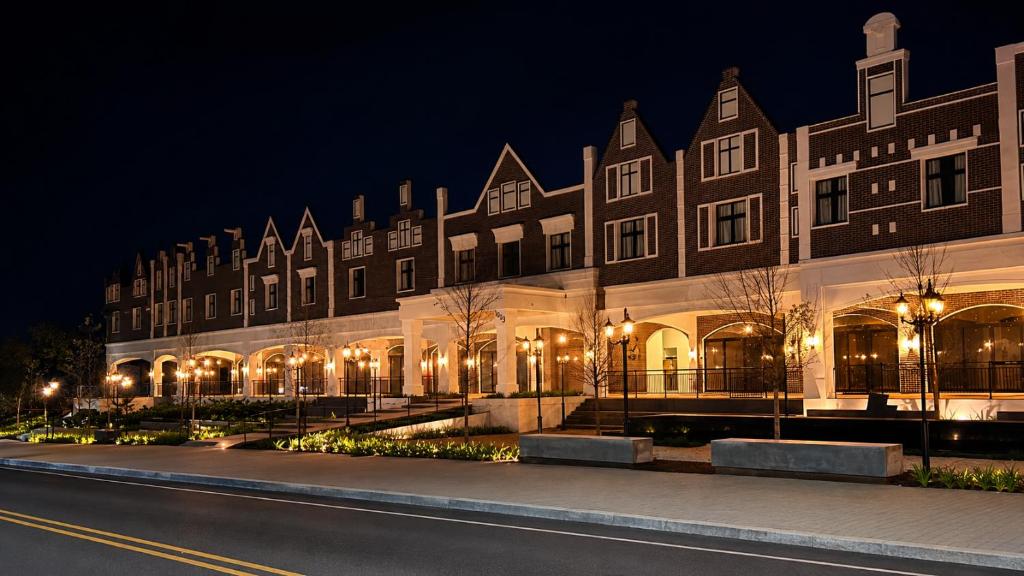 a large building with lights on the side of a street at Welkom Woord - Aluguel Flats e Aptos curta temporada - Entrada com senha in Holambra