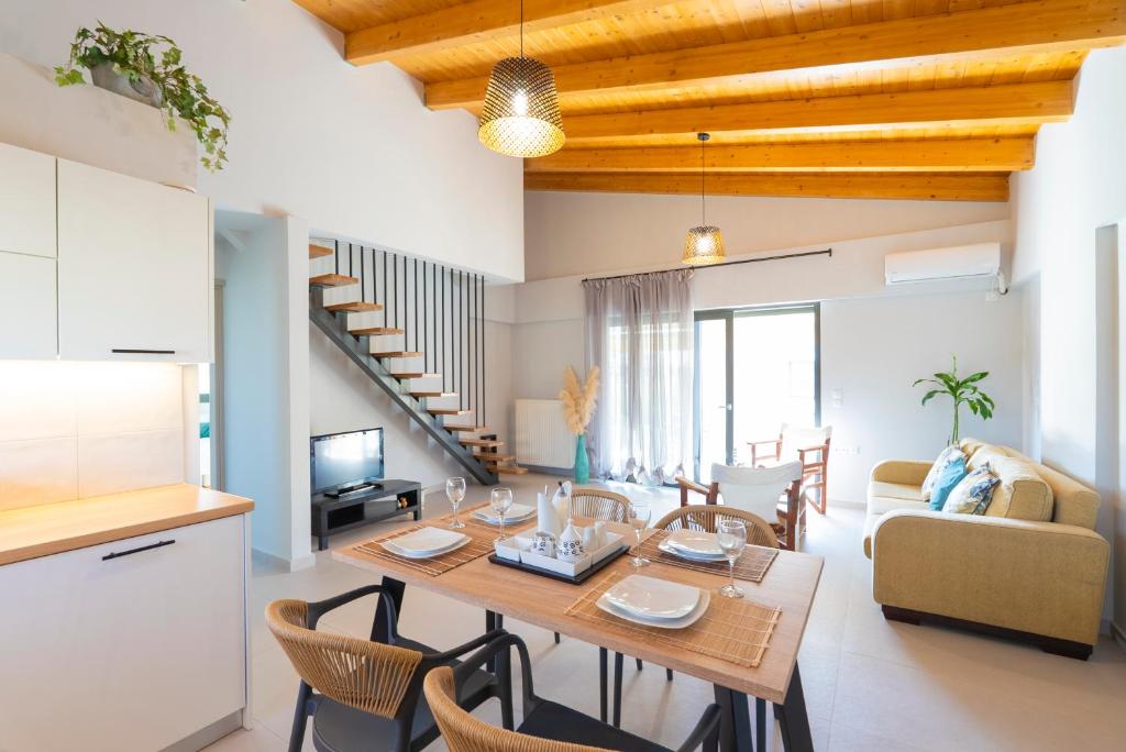 a kitchen and living room with a table and chairs at Lefkada Town Condo in Lefkada