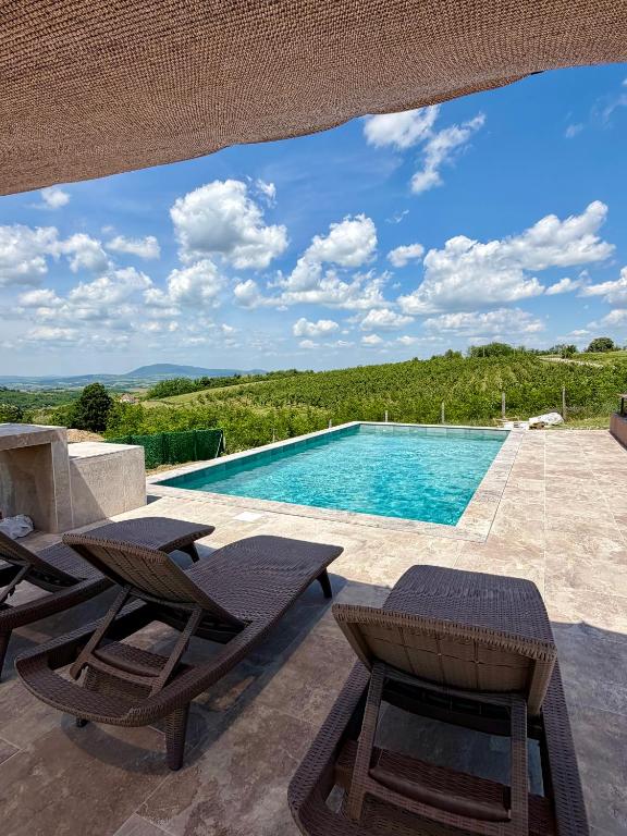 a swimming pool with two lounge chairs and a swimming pool at Rent a NEST in Arandelovac