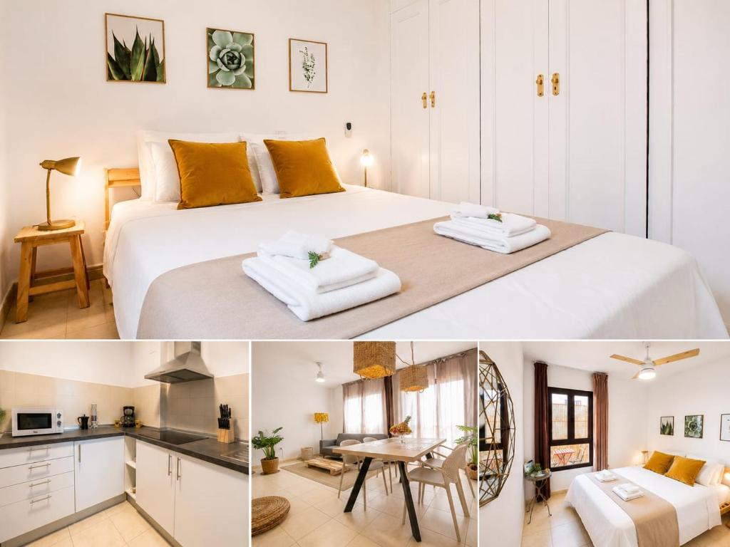 a bedroom with a large white bed and a kitchen at Rincon de Paz in Corralejo