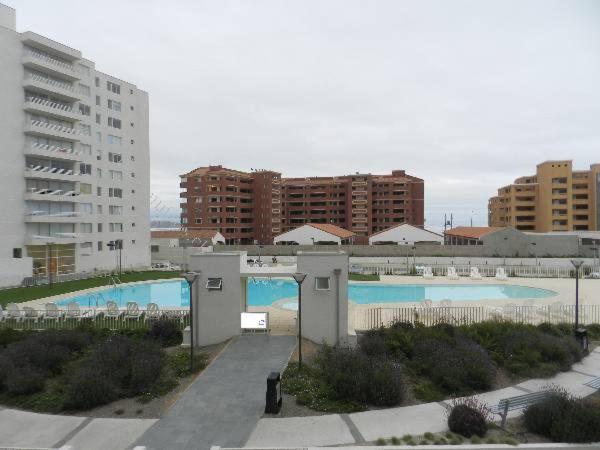 a large swimming pool in a city with buildings at Yasna Gorigoitia in La Serena