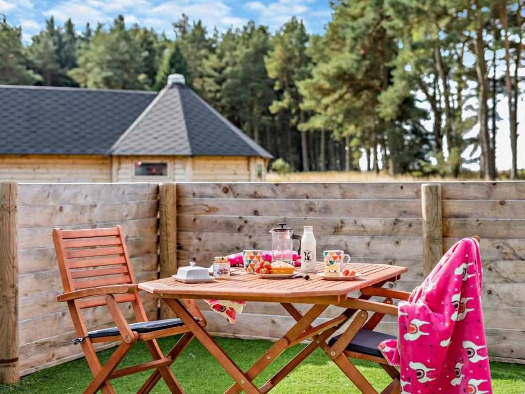 a wooden table and two chairs with food on it at 1 Bed in Lanark oc-91249 in Libberton