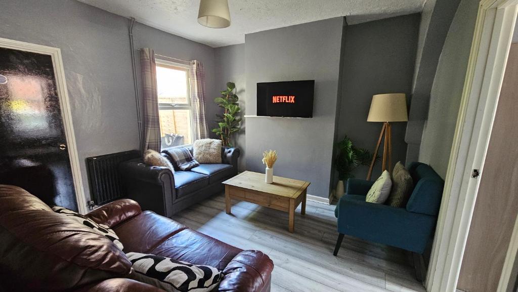 a living room with a leather couch and chairs at Entire 3 bed house in Gloucester in Gloucester