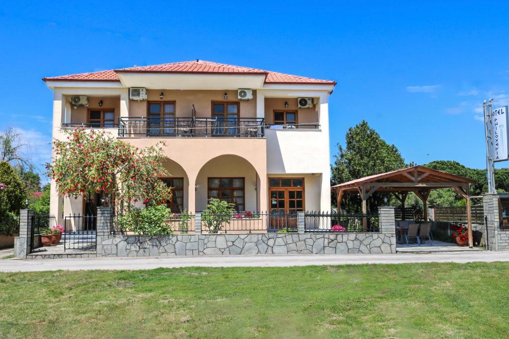 a large house with a balcony and a gazebo at Philoxenia Hotel in Skala Prinou