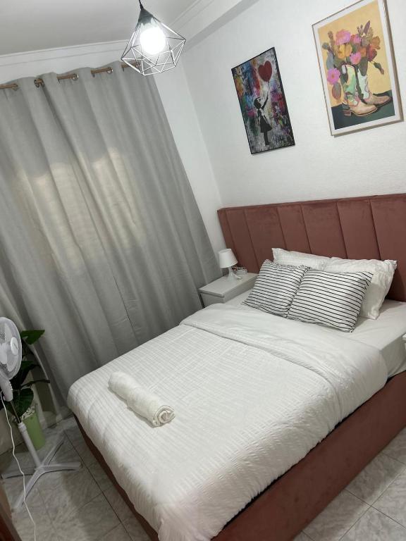 a bedroom with a large bed with white sheets at ABRA residence alverca in Quinta da Verdelha