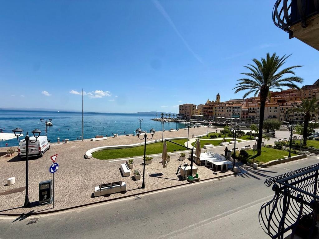 a view of a street with a beach and the ocean at Casa Piazza dei Rioni in Porto Santo Stefano