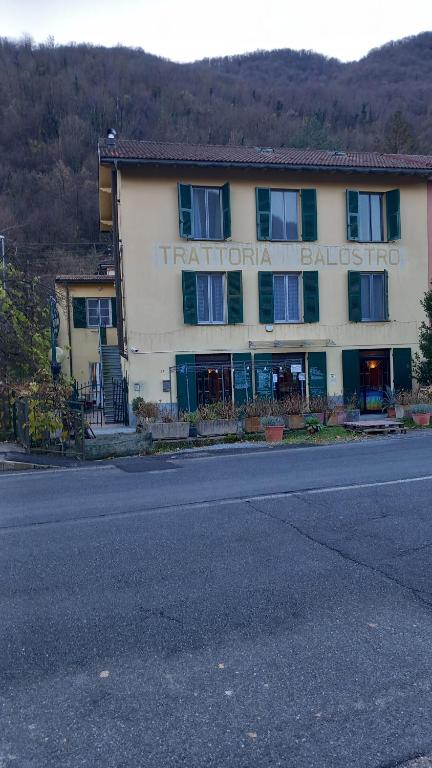 a hotel with a sign on the side of a road at affittacamere de al vecchio scalo in Isola del Cantone