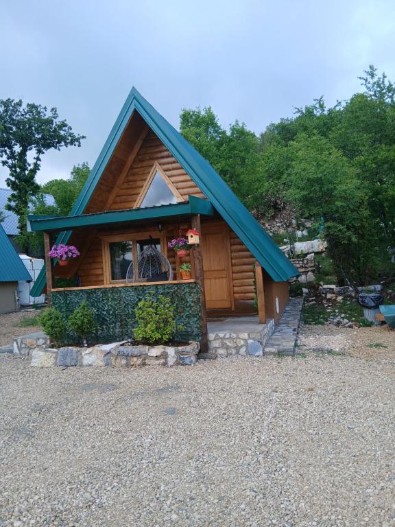 a small cabin with a blue roof at Lake house angela in Kuside
