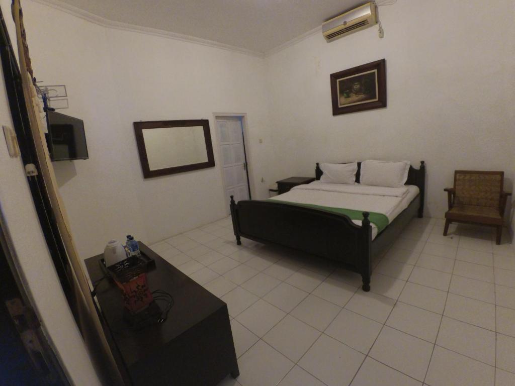 Postel nebo postele na pokoji v ubytování Alam Jogja Resort Mitra RedDoorz