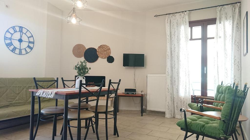 a living room with a table and chairs at Vagionia Apartments in Ancient Epidauros
