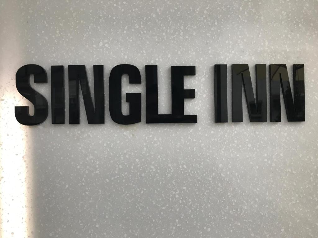 a sign with the word singleim on a wall at Single Inn - Taipei in Taipei