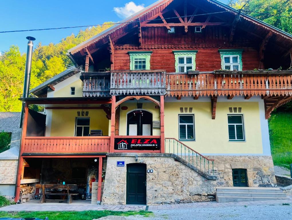 a large wooden house with a balcony at Apartma Elza in Tržič