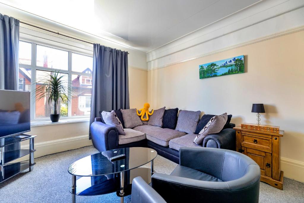 a living room with a couch and a table at Finest Retreats - Seabreeze, Rhos On Sea in Rhos-on-Sea