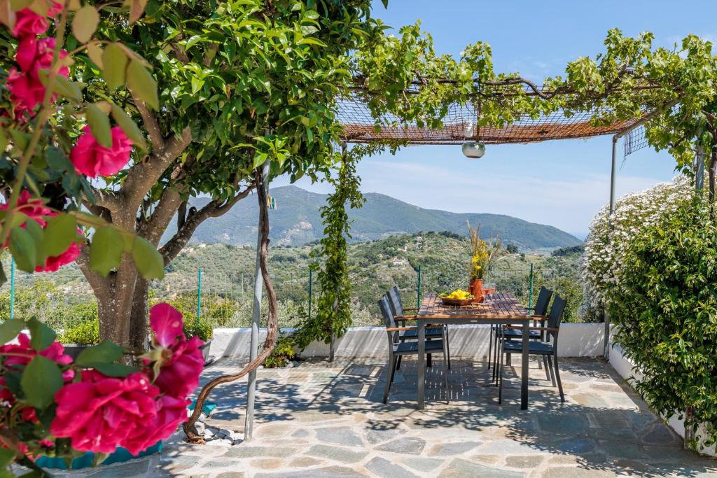 a table and chairs on a patio with a view at Anatoli Peak Cottage in Skopelos Town