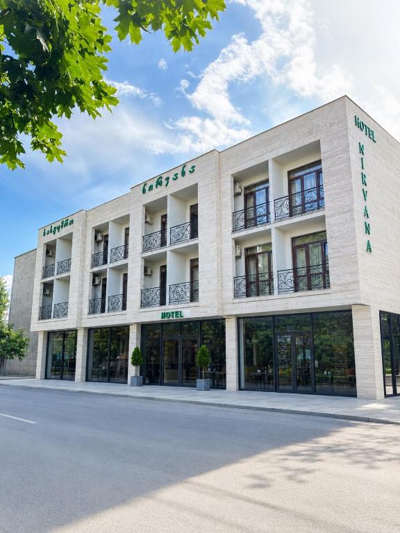 a large white building with the front of it at Hotel Nirvana in Tbilisi City